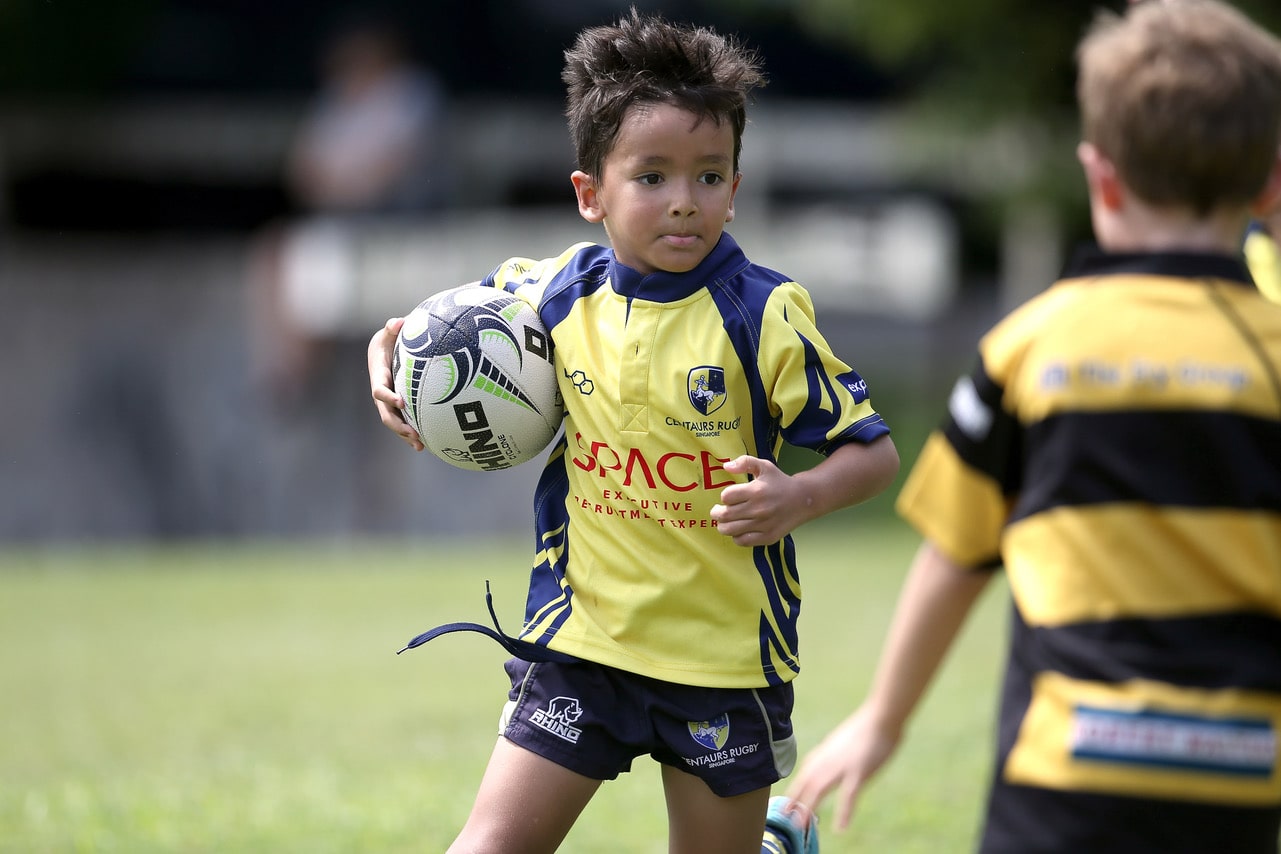 young boy playing rugby