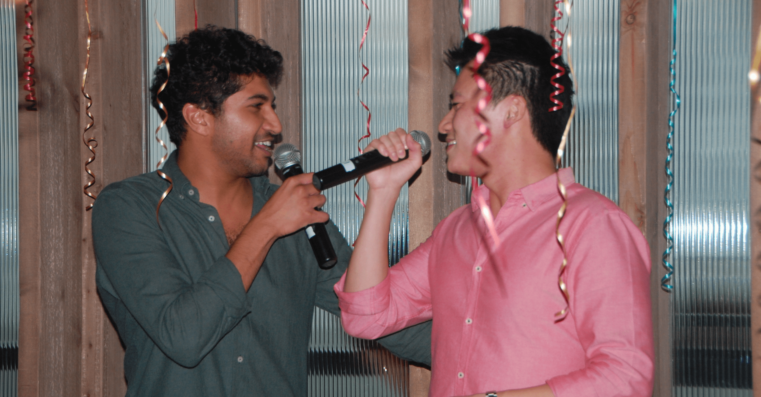 2 men singing karaoke