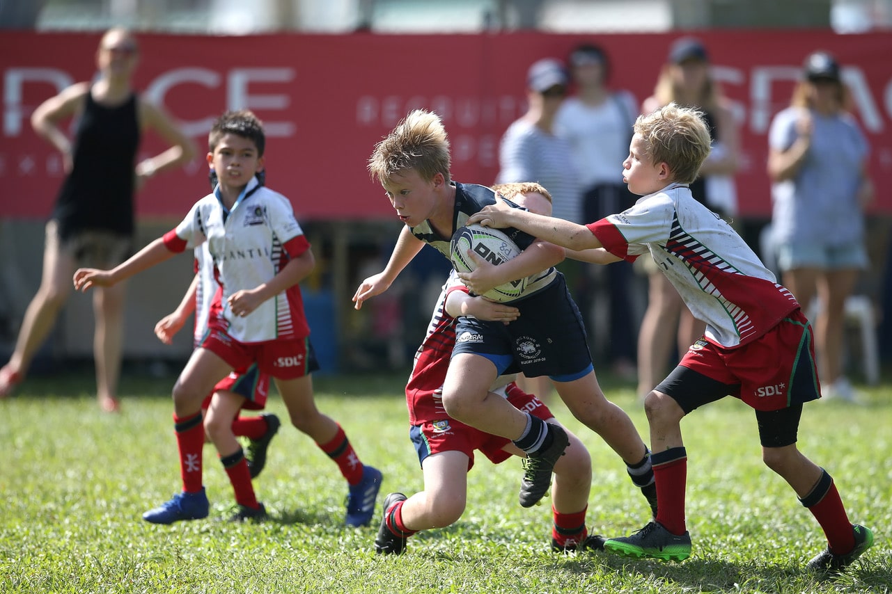young boys playing rugby