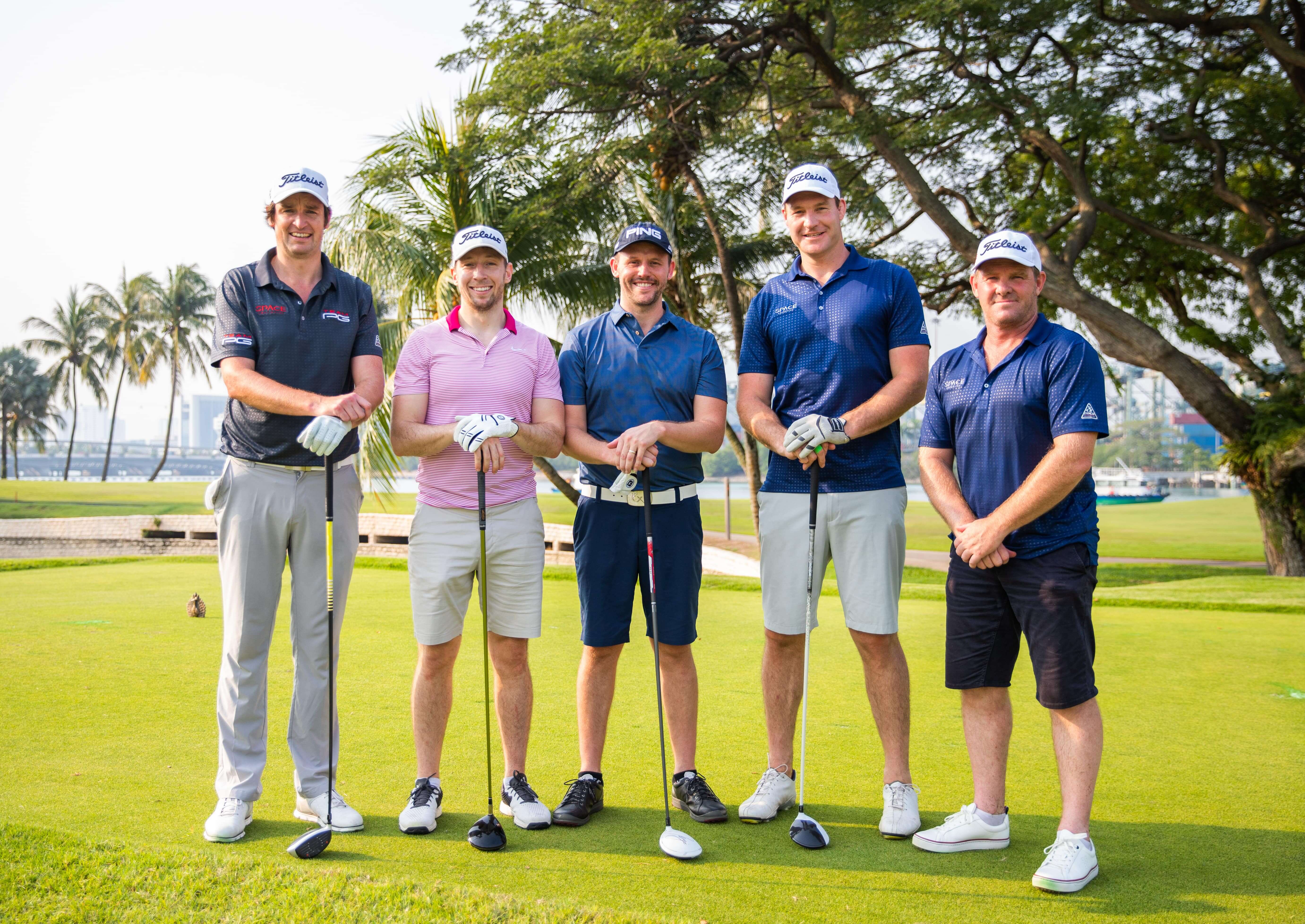 5 golfers smiling at camera
